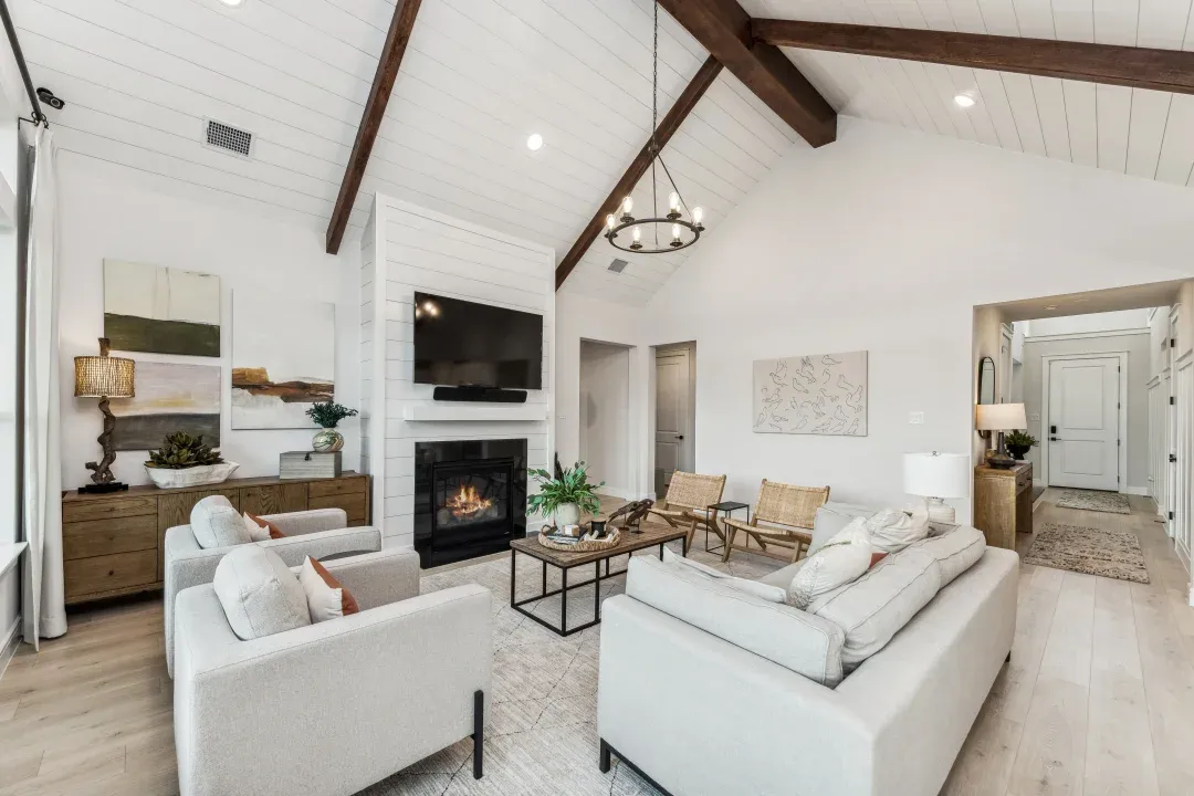 Great room with vaulted ceiling, stained ceiling beams and shiplap