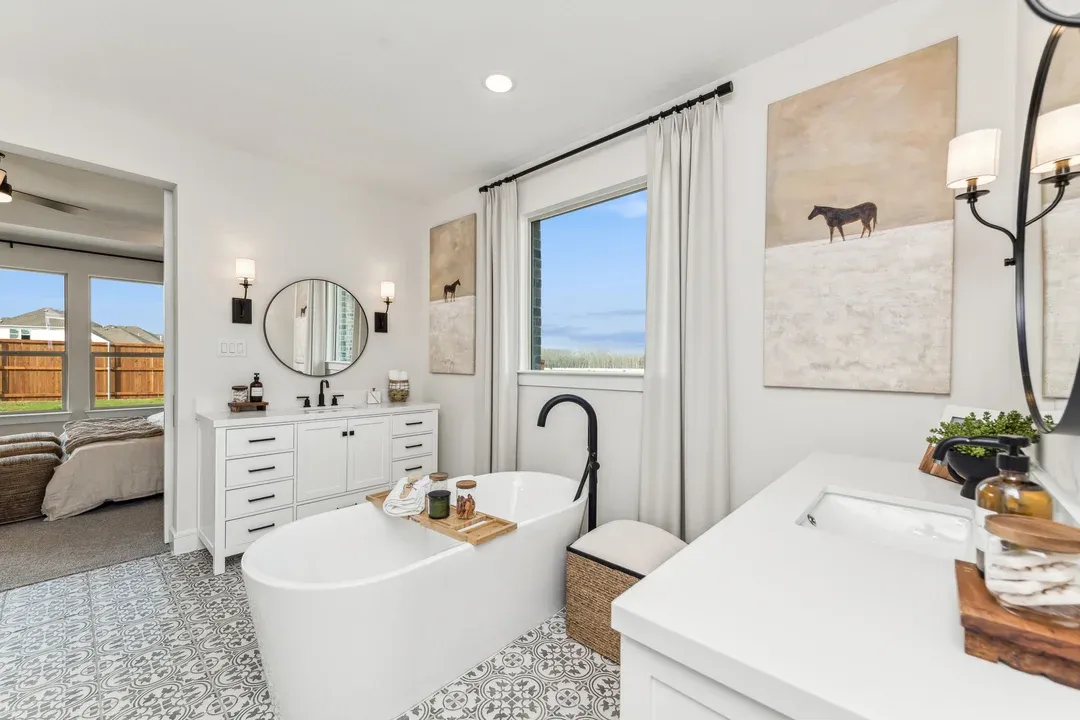 Primary bath with dual freestanding vanities and soaking tub
