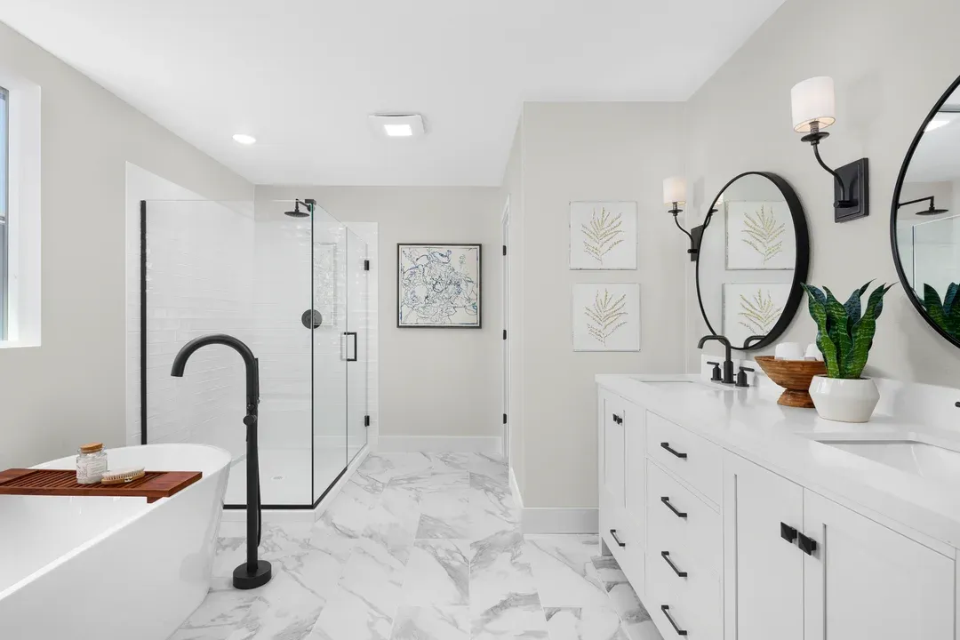 Primary bath with freestanding tub, freestanding vanity and glass shower enclosure