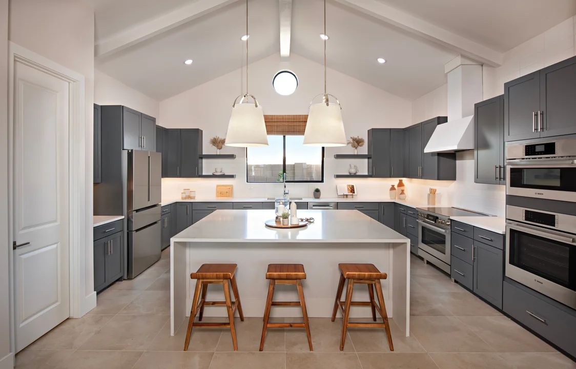 Kitchen with white stained ceiling beams and vaulted ceiling