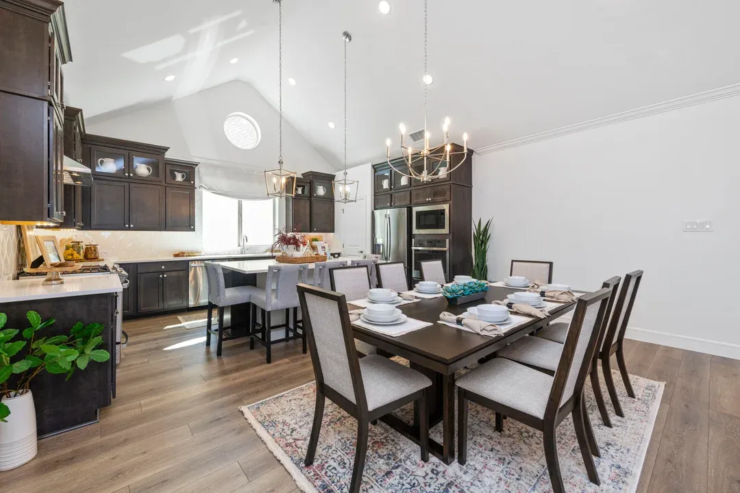 Dining area with vaulted ceiling and chandeliers