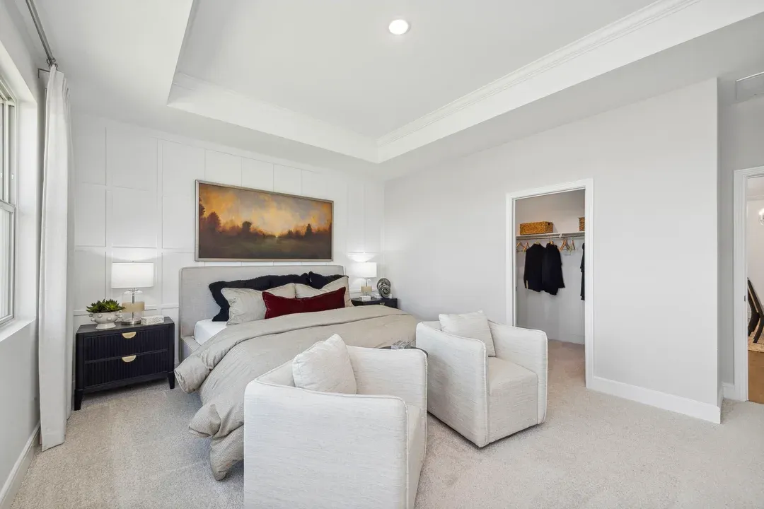Primary suite with walk-in closet and plush carpeting throughout