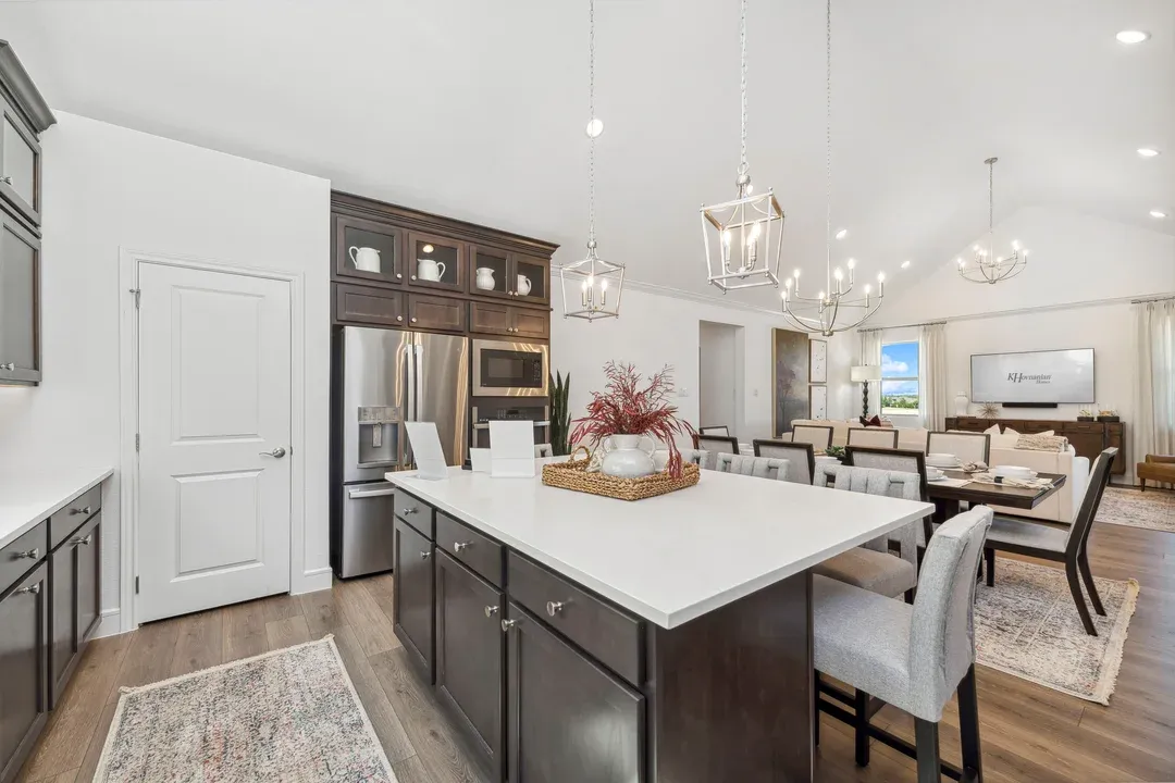 Kitchen with vaulted ceiling overlooking dining area