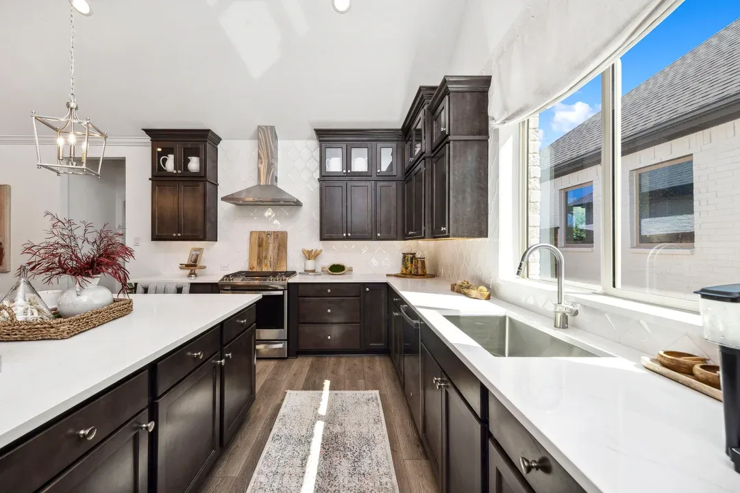 Kitchen with stainless steel appliances and glass upper cabinets