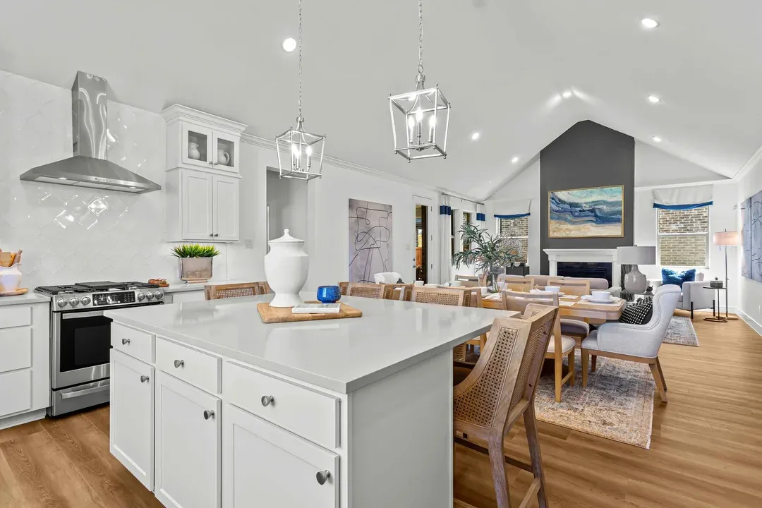 Kitchen with large island adjacent to dining area and great room