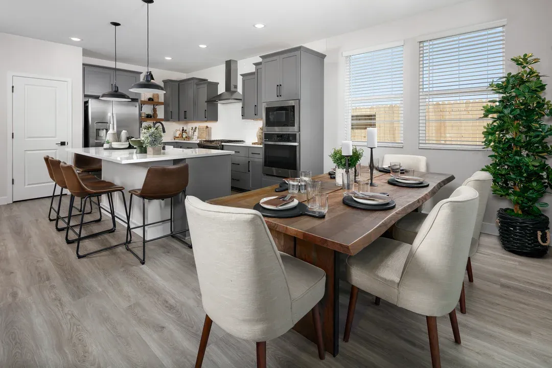 Kitchen with cozy dining area featuring stunning wood flooring