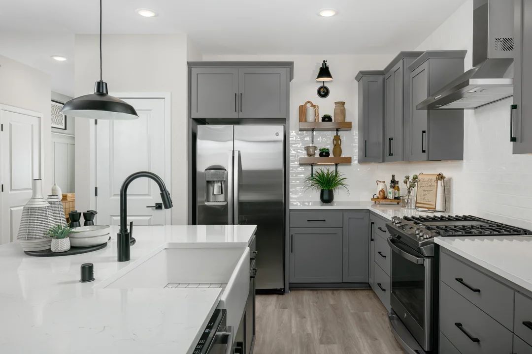 Kitchen with floating shelves and stainless steel appliances