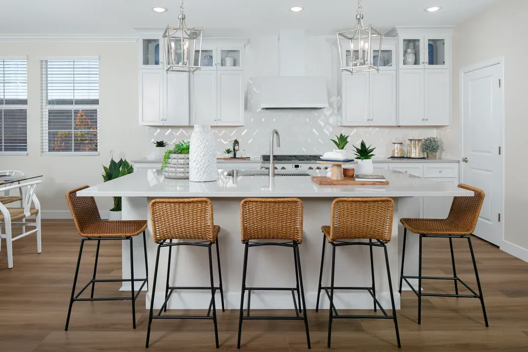 Kitchen with glass upper cabinets and pendant lighting