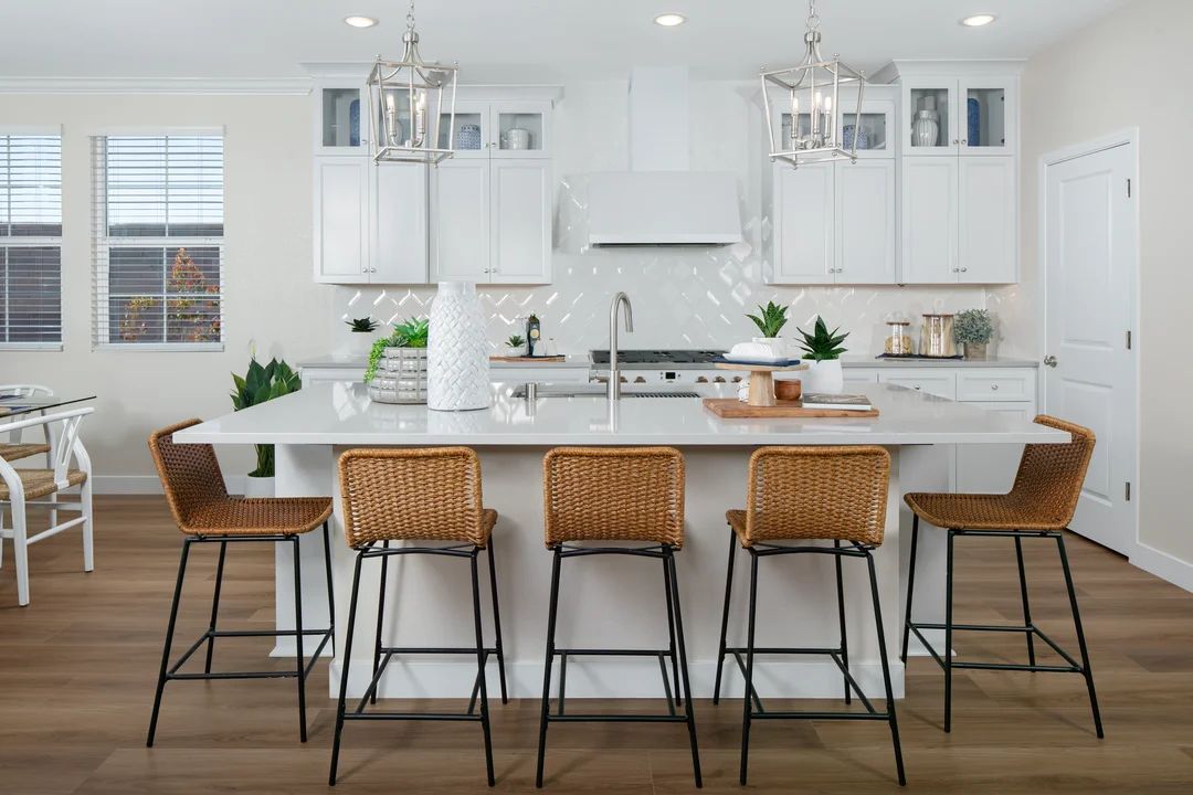 Kitchen with glass upper cabinets and pendant lighting