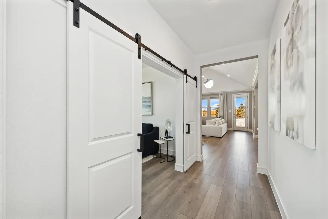 Foyer with double barn doors leading to home office