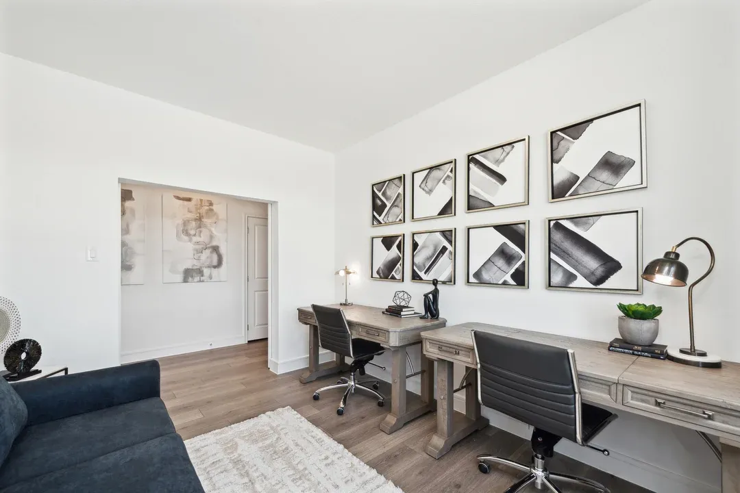 Home office with gorgeous flooring and double barn doors