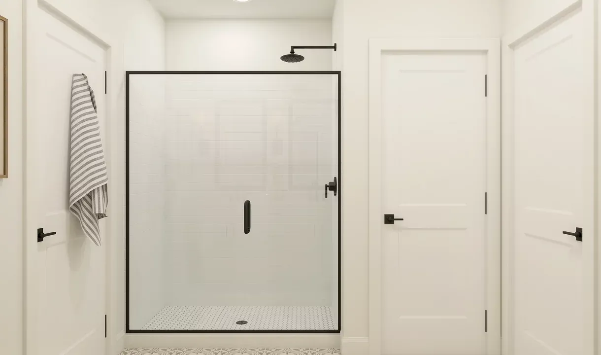 Glass shower enclosure with matte black finishes