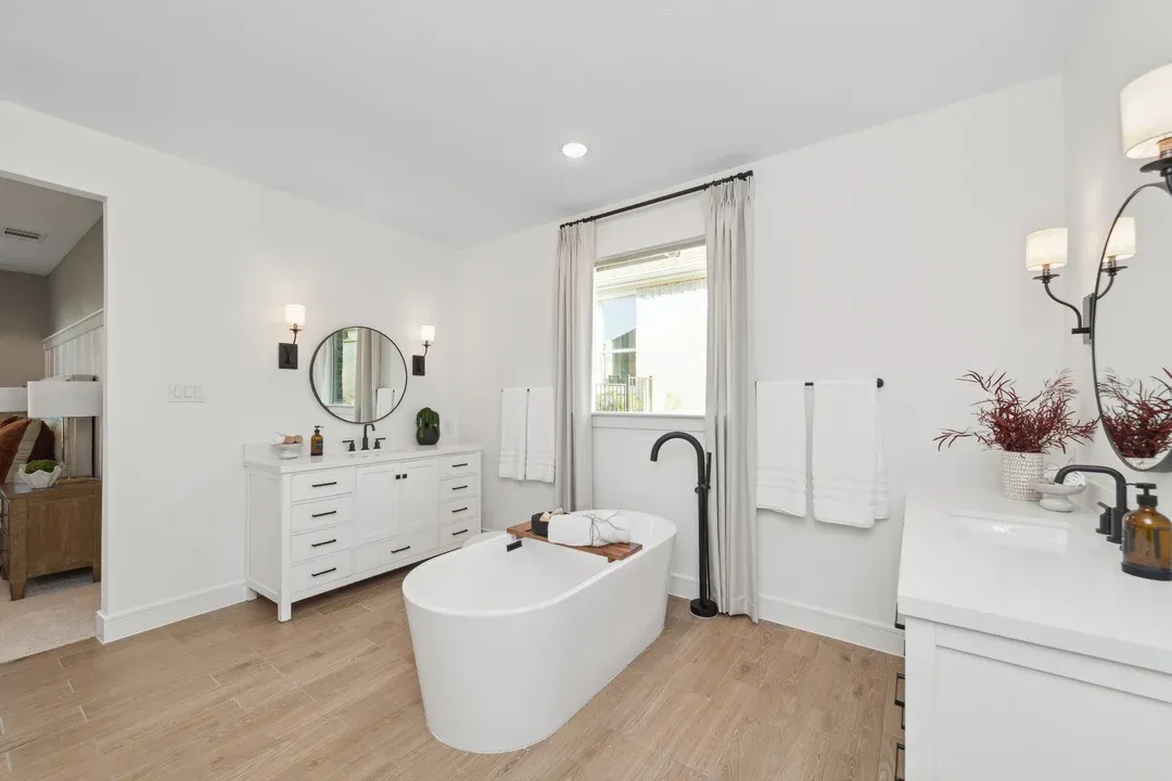 Primary bath with freestanding tub and dual vanities