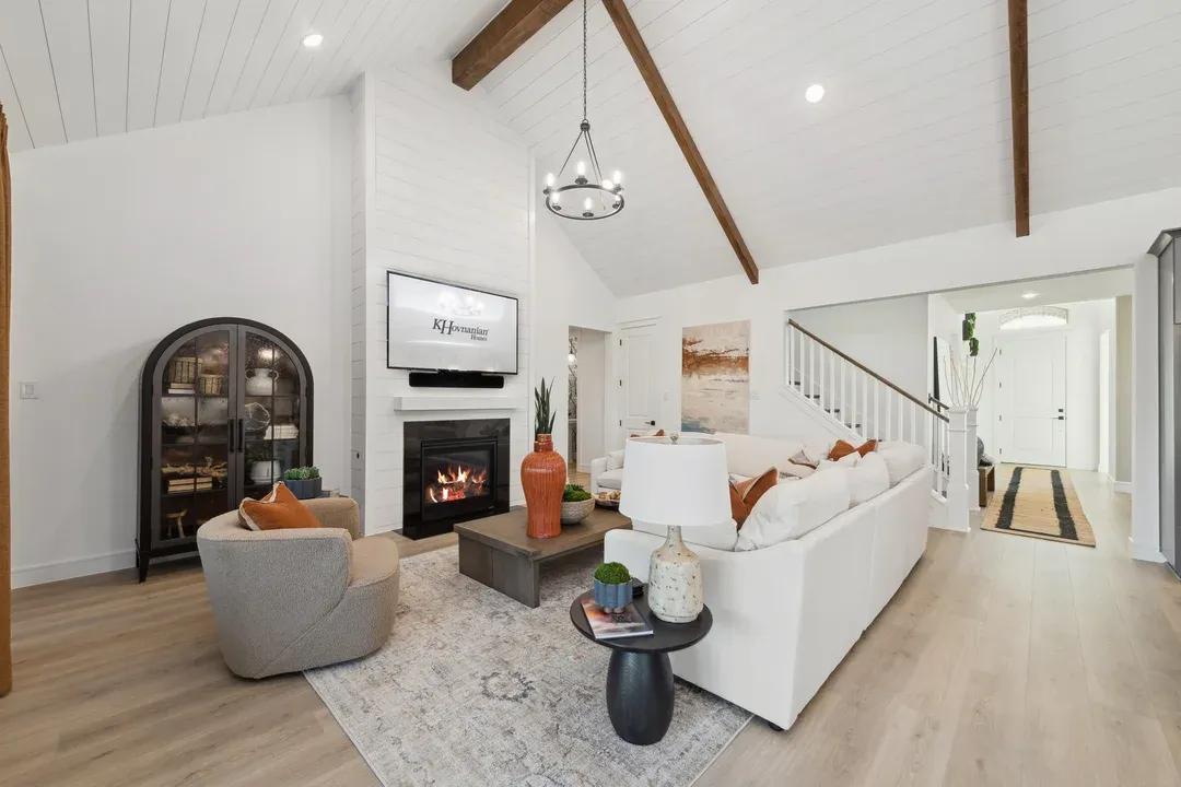 Great room with stained ceiling beams and vaulted ceiling