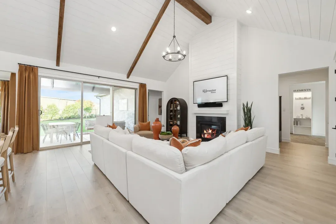 Great room with stained ceiling beams and vaulted ceiling