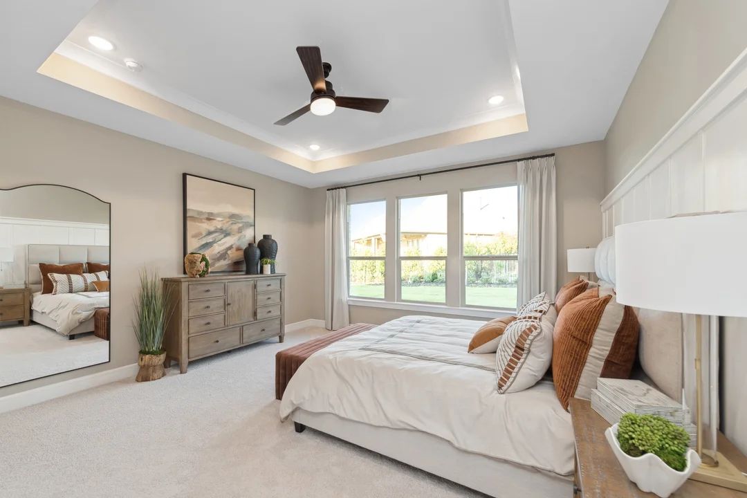 Primary suite with crown moulding and walk-in closet