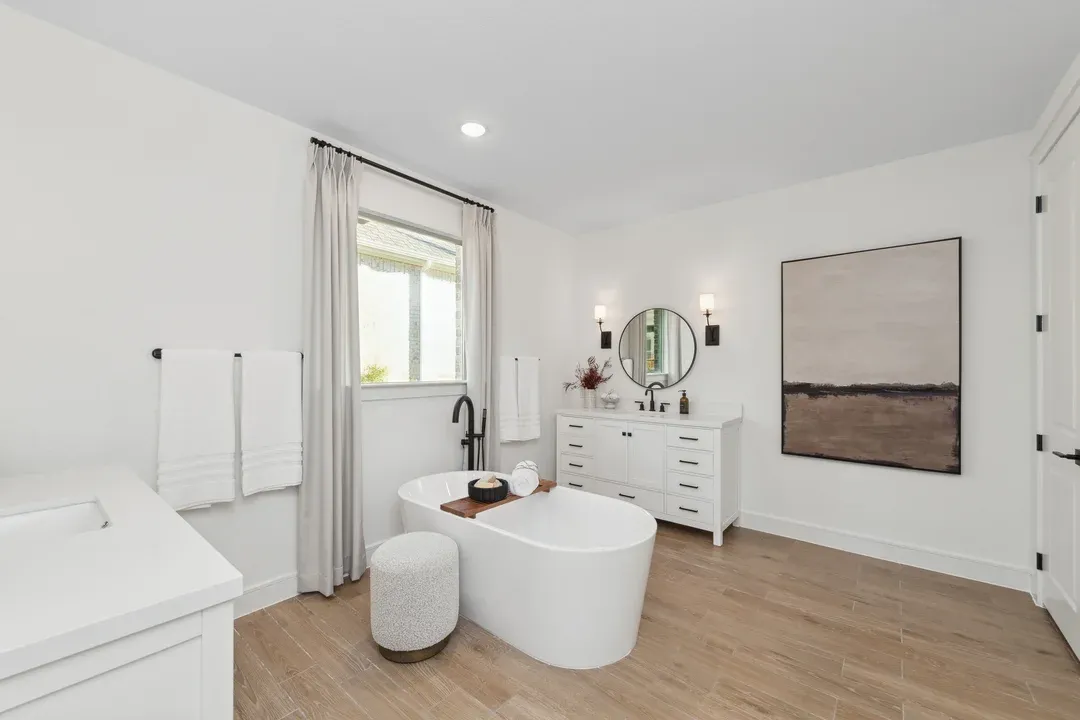 Primary bath with freestanding tub and dual vanities