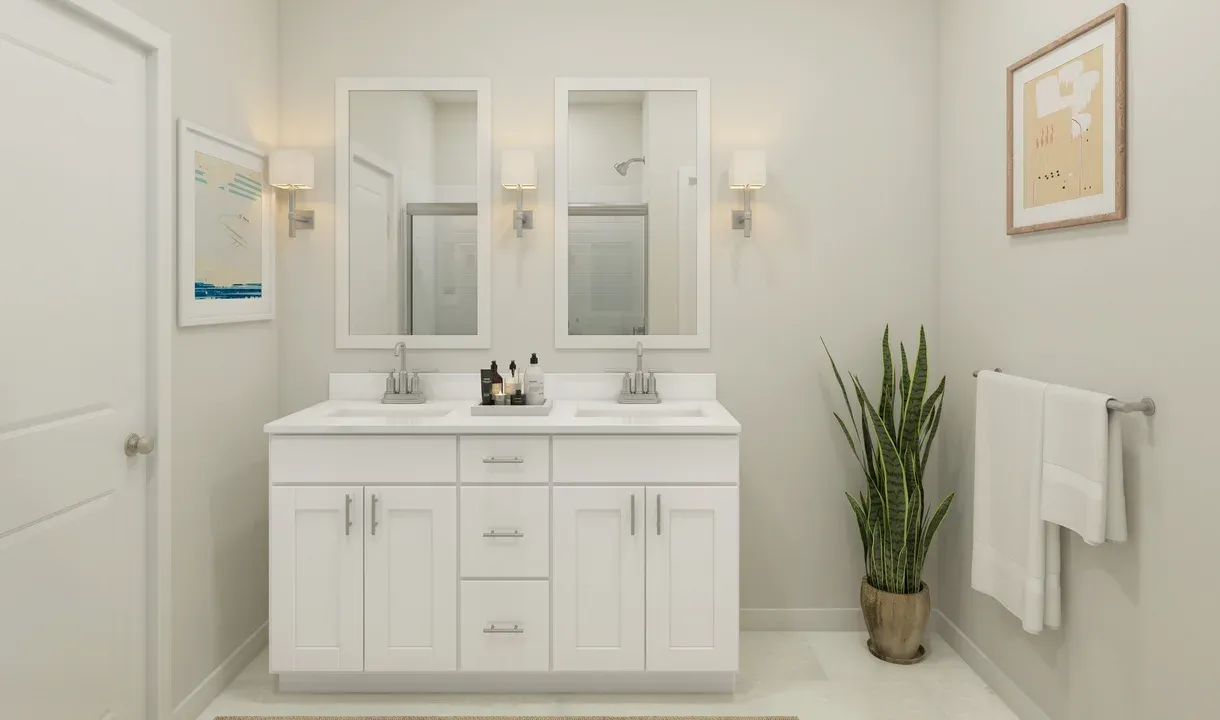 Primary bath with chrome fixtures and white framed mirrors