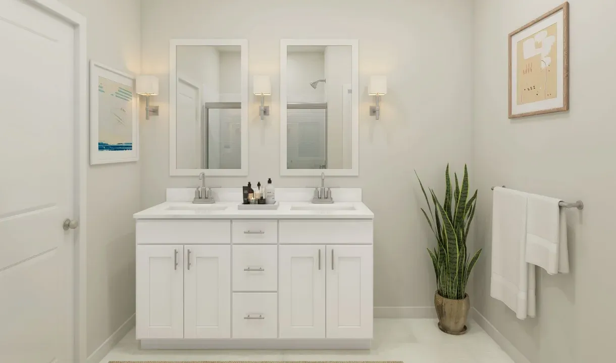 Primary bath with chrome fixtures and white framed mirrors