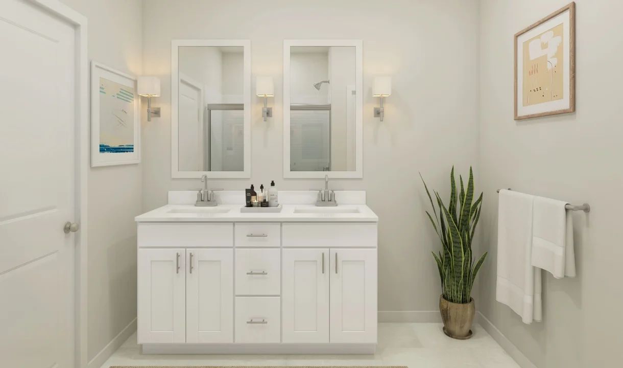 Primary bath with chrome fixtures and white framed mirrors