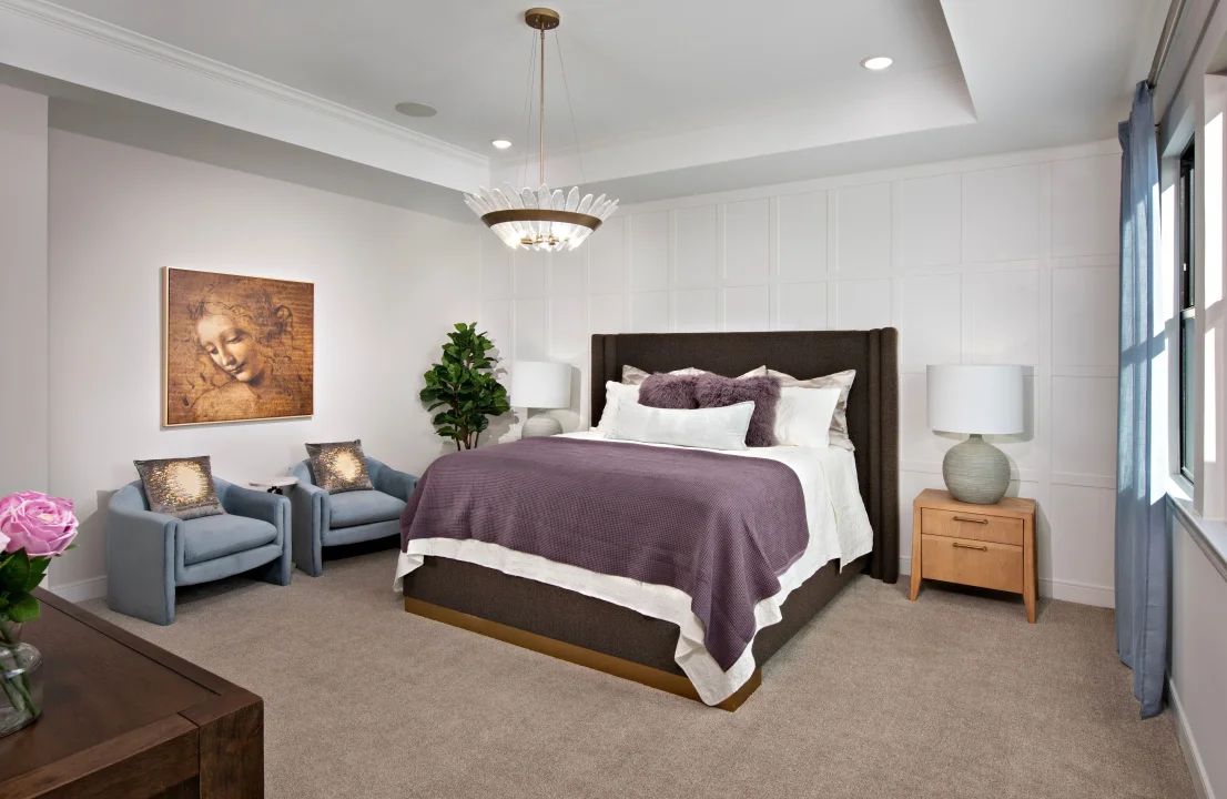 Primary suite with coffered ceiling and decorative feature wall