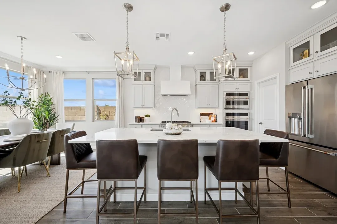 Kitchen with glass upper cabinets and pendant lighting