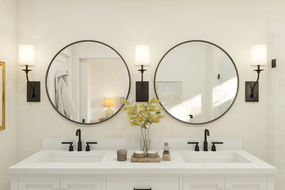 Matte black mirrors and sconces in primary bath