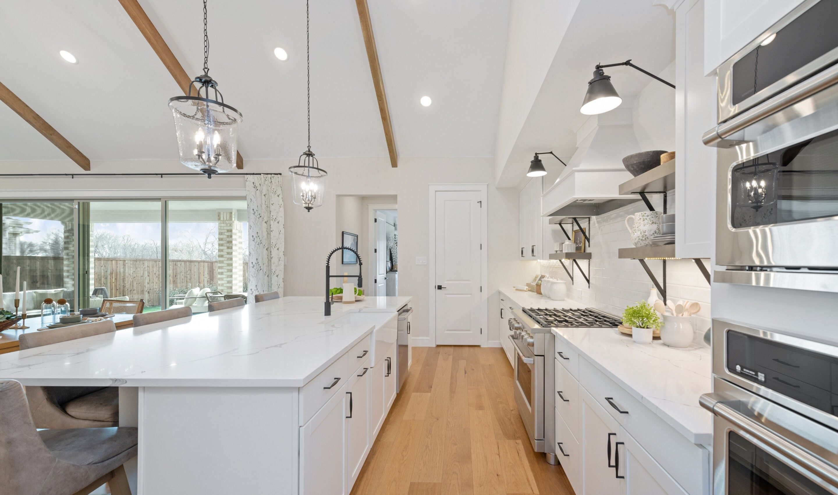 Kitchen with stainless steel appliances and high ceilings