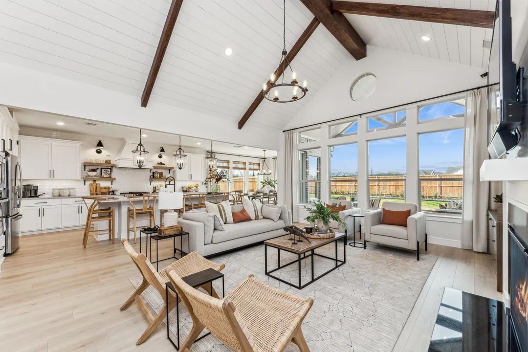 Great room featuring soaring vaulted ceiling with stained beams