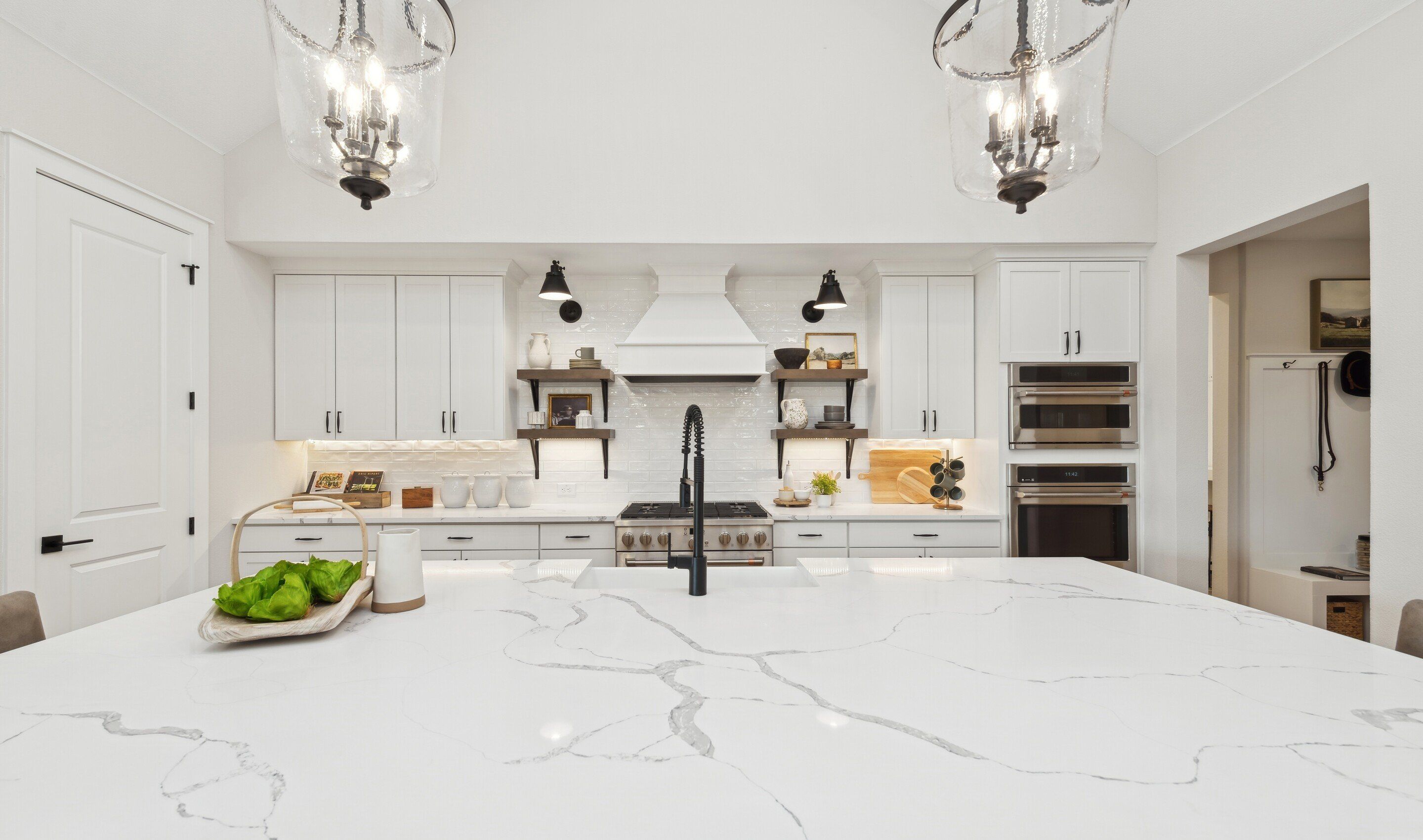 Kitchen with floating shelves and quartz countertops