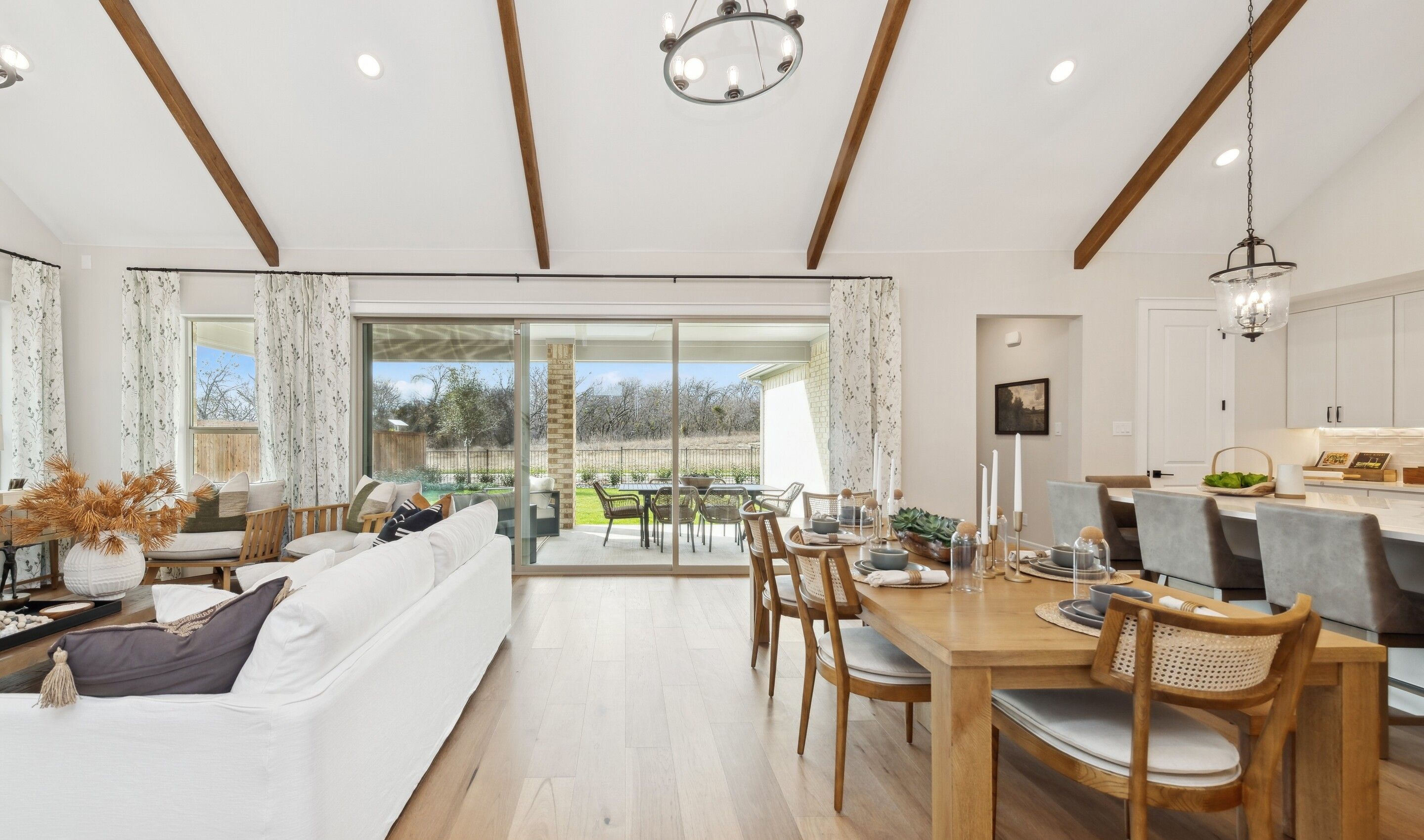 Dining area with vaulted ceiling and stained ceiling beams