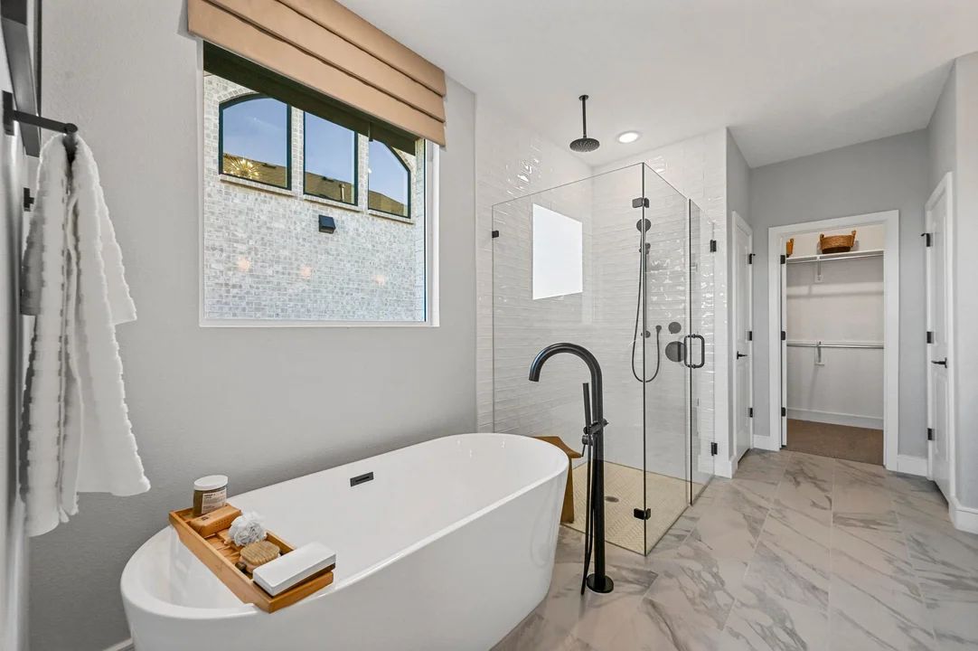 Primary bath with freestanding tub and glass shower enclosure