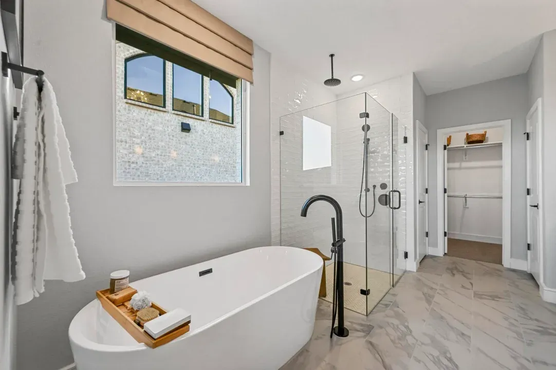 Primary bath with freestanding tub and glass shower enclosure