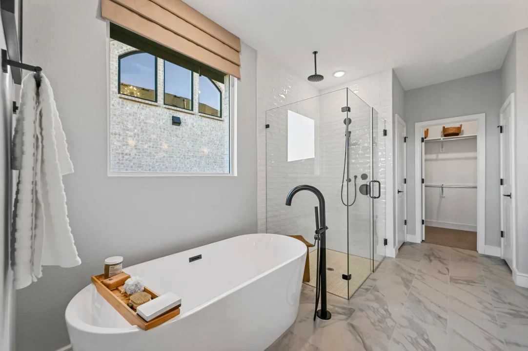 Primary bath with freestanding tub and glass shower enclosure