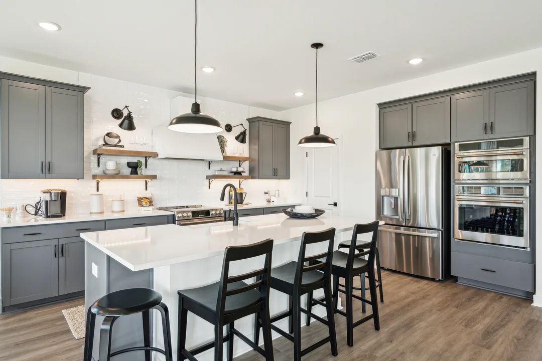 Kitchen with vast island and pendant lights