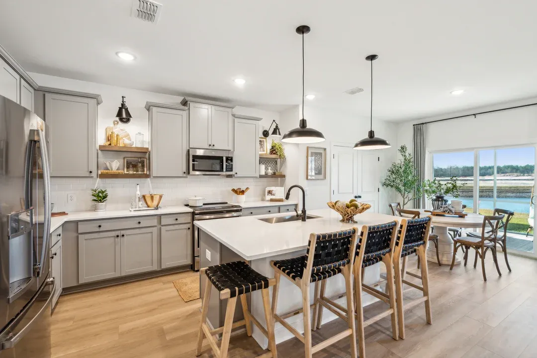 Kitchen featuring vast island and pendant lights