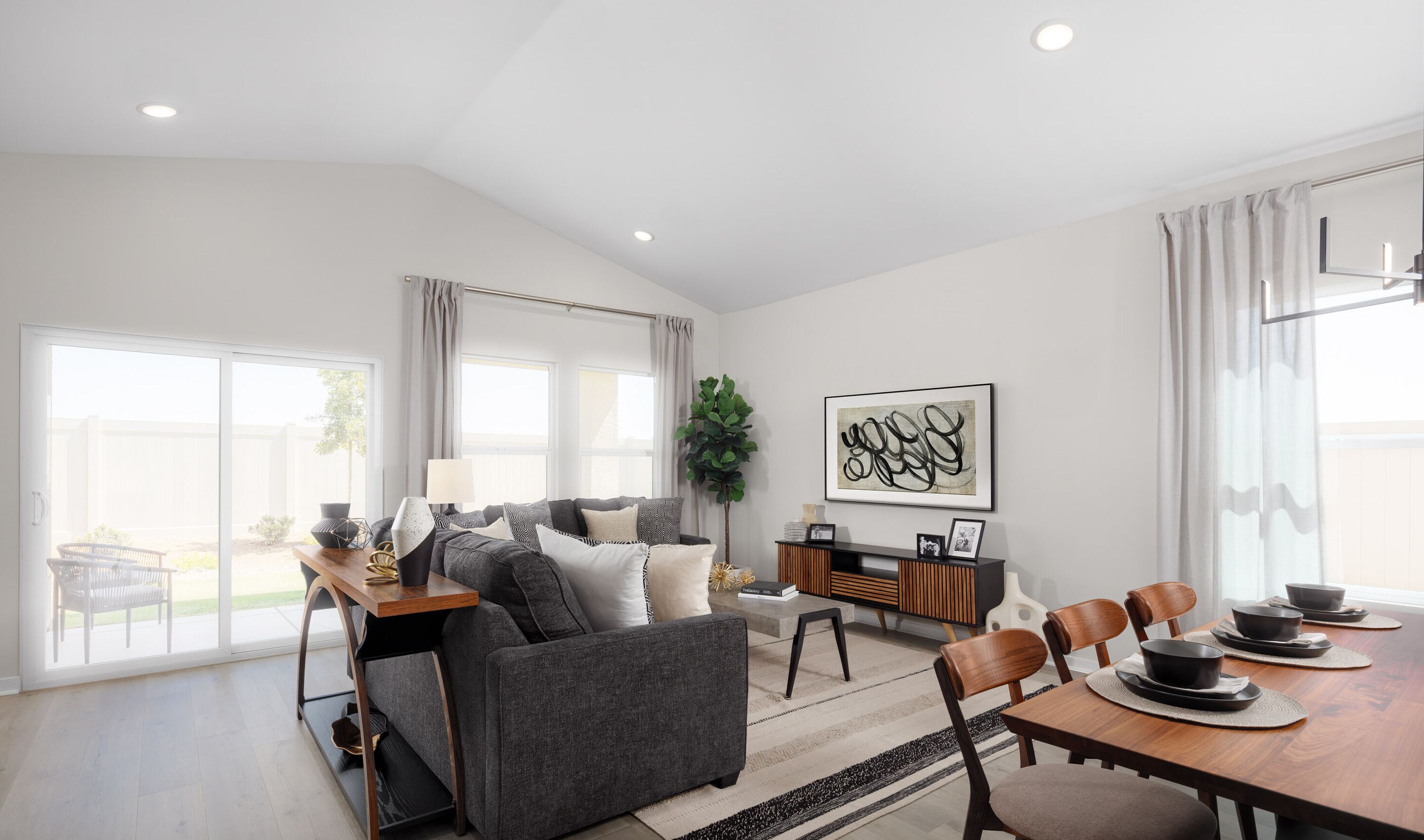 Open concept living spaces with vaulted ceiling