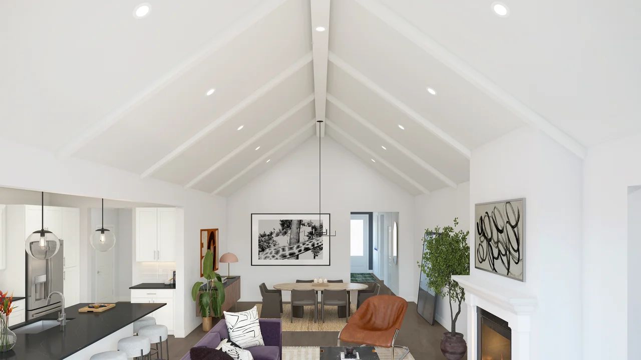 Vaulted ceiling with white-painted ceiling beams and fireplace