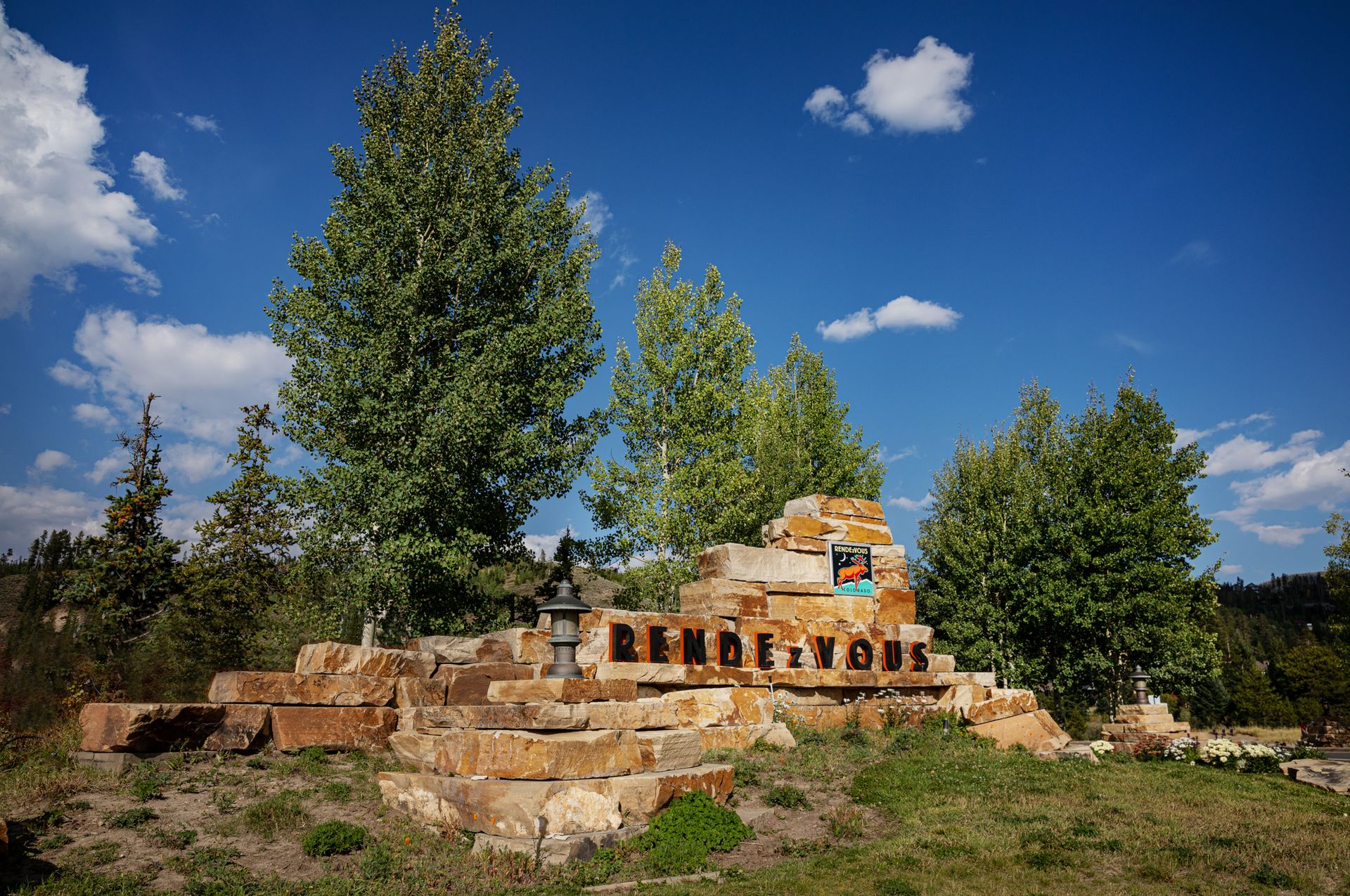 The Rendezvous entrance monument sets the tone for what’s ahead — welcoming you home with a bold sense of place, mountain character, and a lasting first impression.