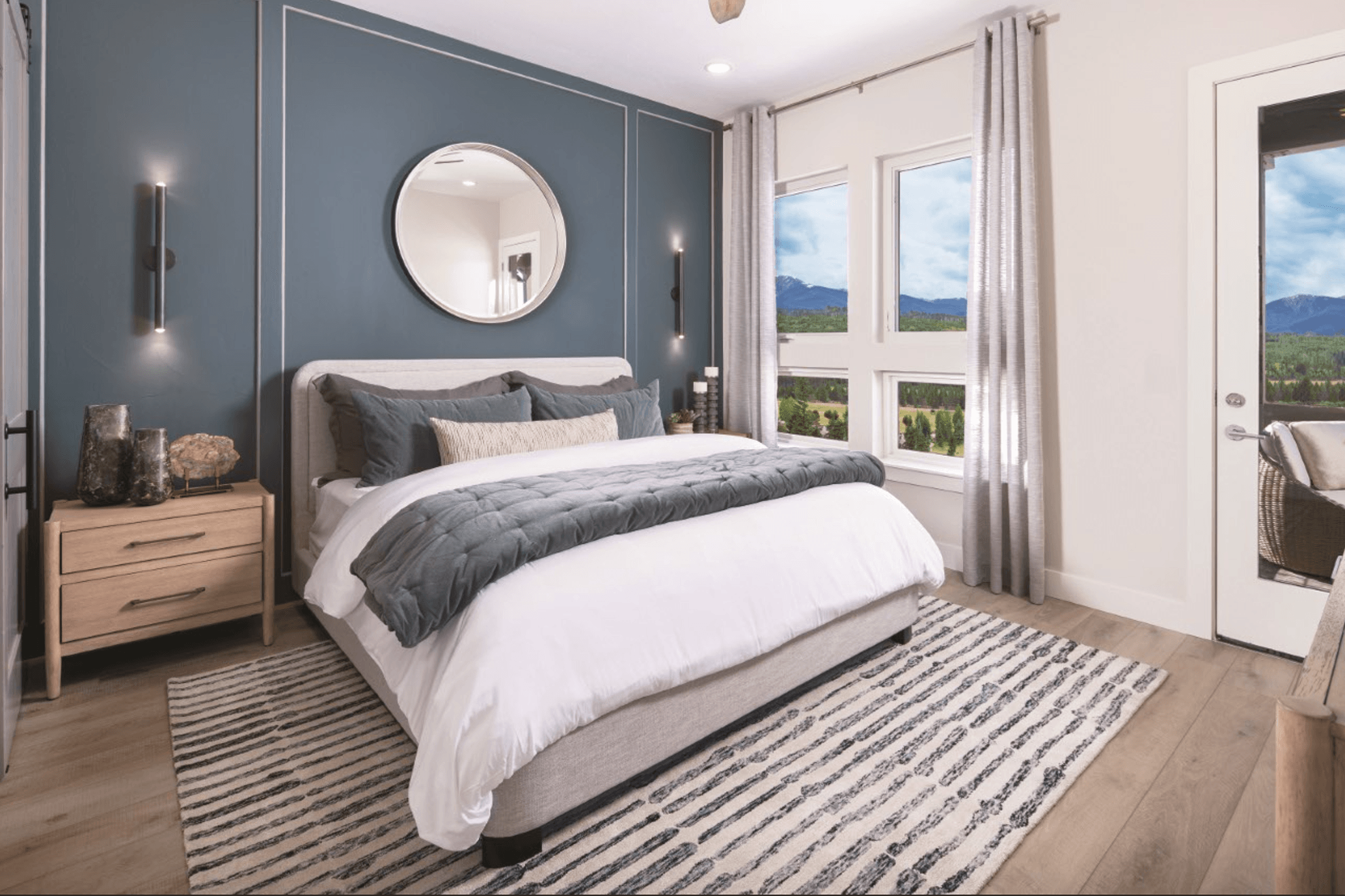 The primary suite is conveniently located on the main level of the home and features private patio access, offering a peaceful retreat that seamlessly connects indoor comfort with outdoor living.