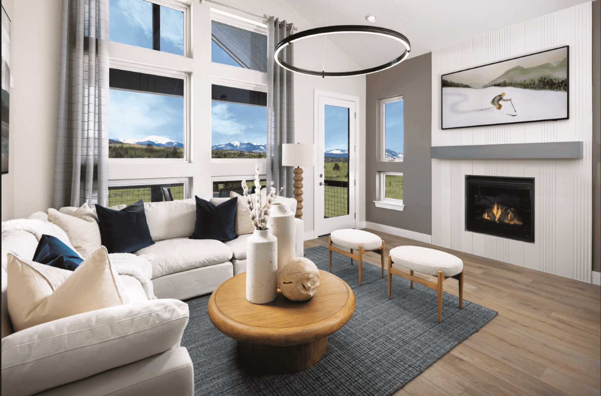 The living room features vaulted ceilings that create an open, airy feel and is conveniently located beside the patio for seamless indoor-outdoor living and easy access to outdoor space.