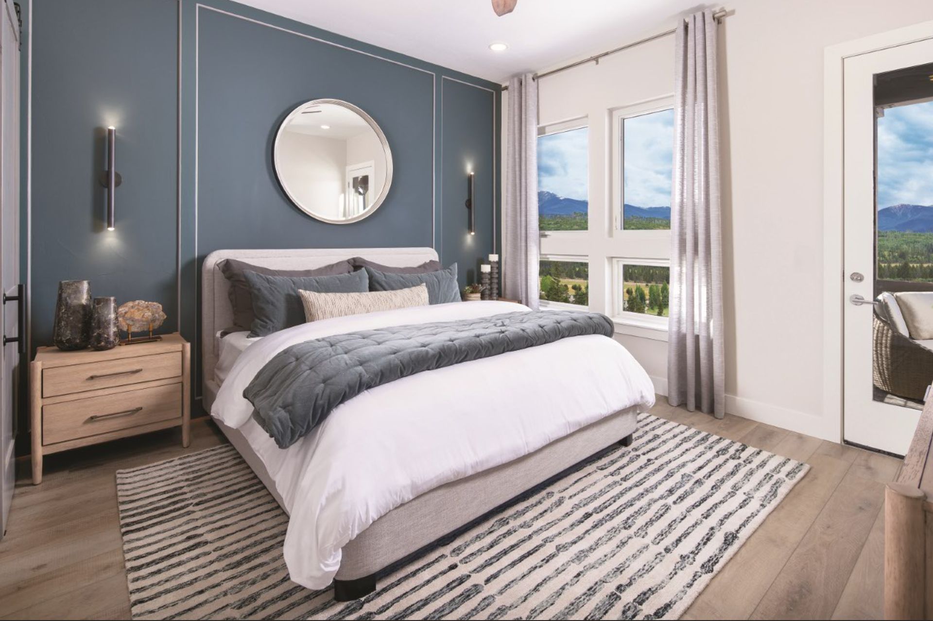 The primary suite is conveniently located on the main level of the home and features private patio access, offering a peaceful retreat that seamlessly connects indoor comfort with outdoor living.