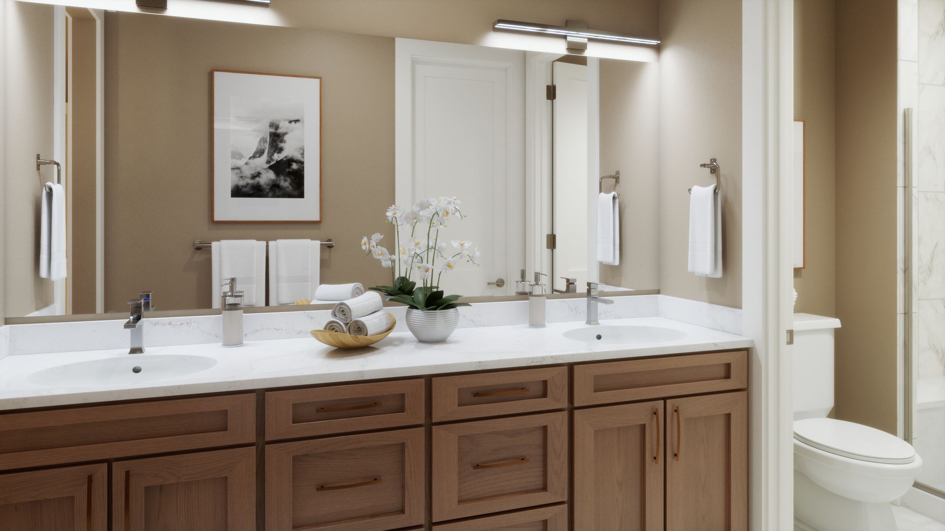 Designed for comfort and functionality, this primary bath features dual vanities, warm finishes, and a separate private space for the shower, creating a thoughtful layout for everyday living.
