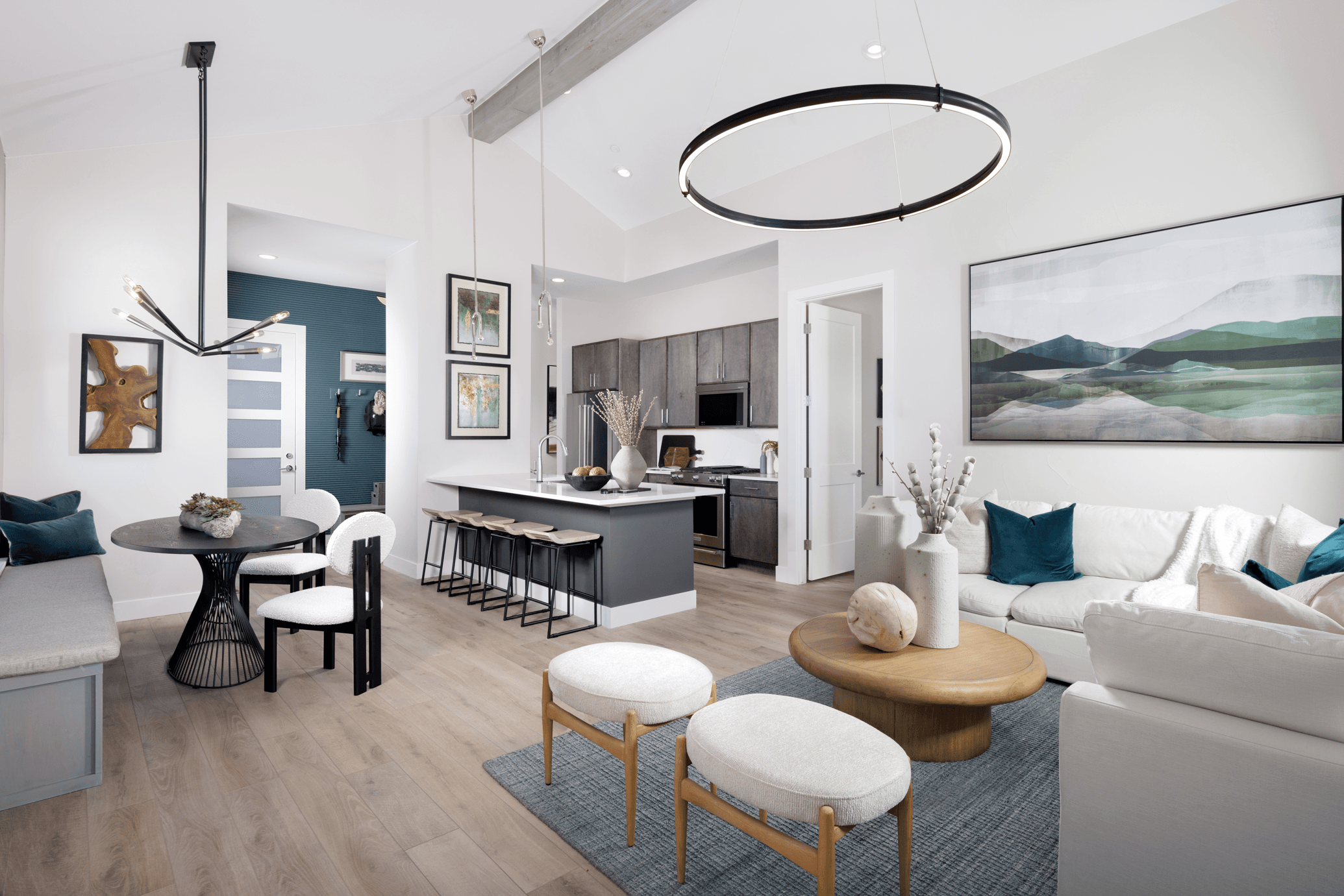 The living room features vaulted ceilings that create an open, airy feel and is conveniently located beside the patio for seamless indoor-outdoor living and easy access to outdoor space.