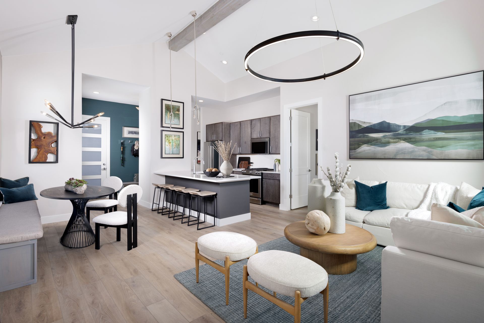 The living room features vaulted ceilings that create an open, airy feel and is conveniently located beside the patio for seamless indoor-outdoor living and easy access to outdoor space.