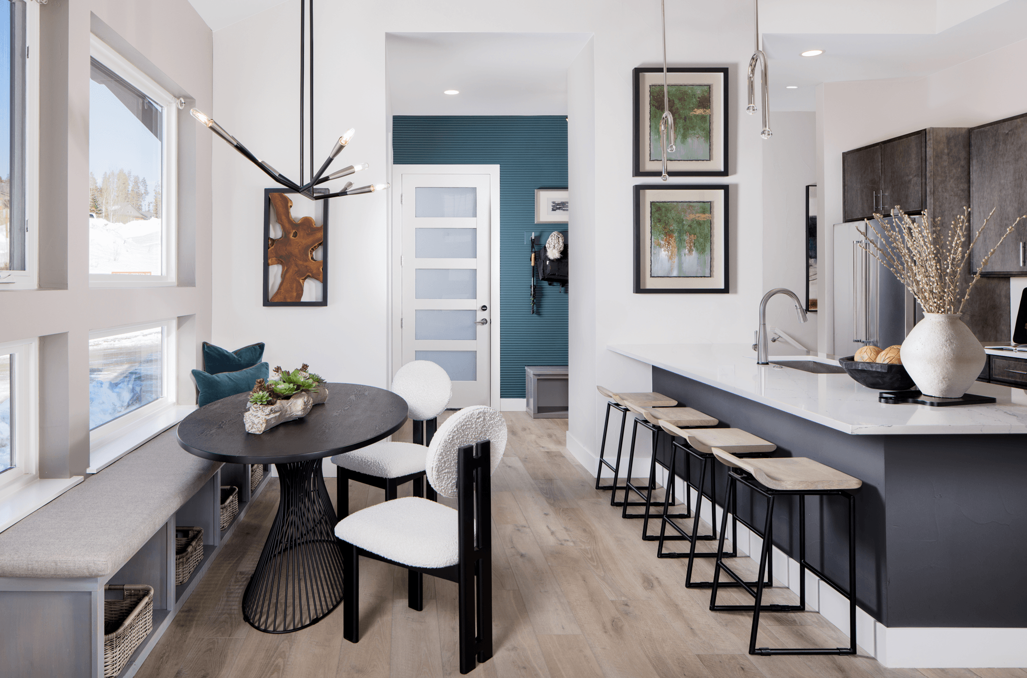 The dining space offers a warm and inviting setting, featuring a built-in bench that adds both style and functionality. Perfectly designed for gatherings, it creates a cozy spot for meals, conversation, and everyday living.