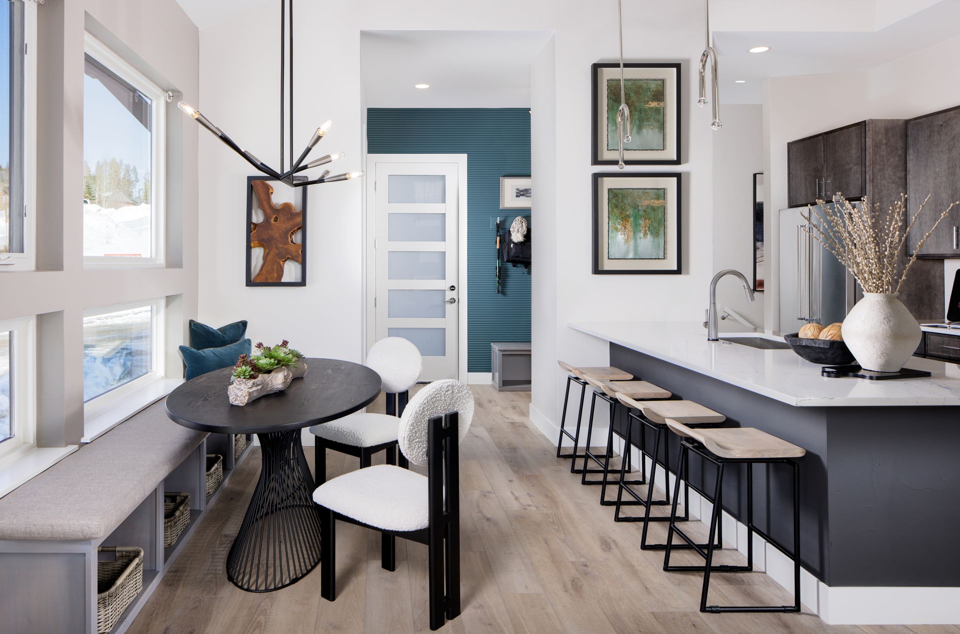 The dining space offers a warm and inviting setting, featuring a built-in bench that adds both style and functionality. Perfectly designed for gatherings, it creates a cozy spot for meals, conversation, and everyday living.