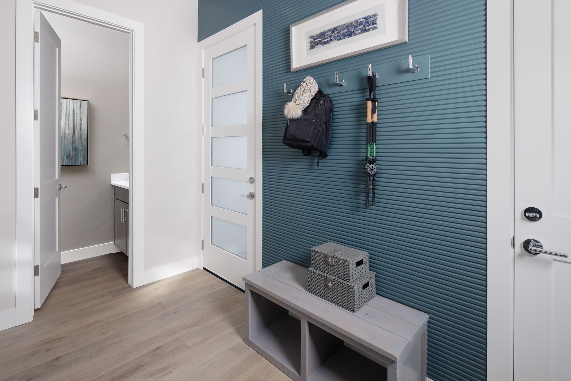 The entry level welcomes you with built-in storage shelves and hooks right as you walk in, creating an organized and functional drop zone, along with a conveniently located powder bath for everyday ease.