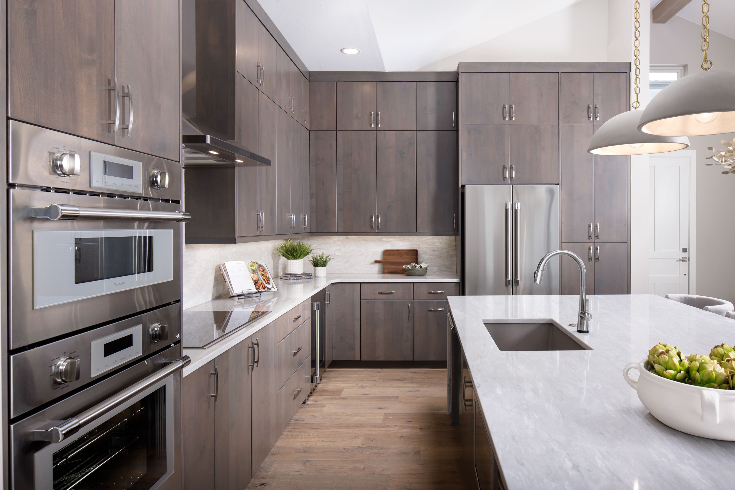 The Osprey kitchen features a massive waterfall island, abundant cabinet space, and premium Thermador appliances. Designed for both style and function, it’s the perfect centerpiece for cooking, gathering, and entertaining in the heart of the home.