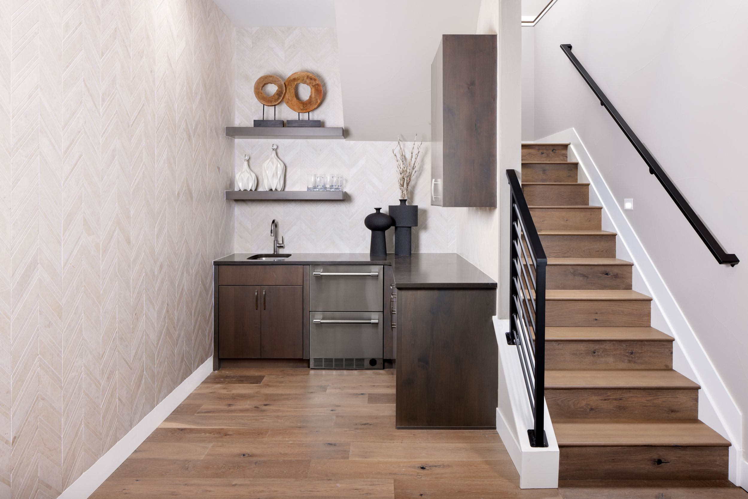 The lower level features a stylish wet bar, adding the perfect touch for entertaining, relaxing, and enjoying time with family and friends in this versatile space.